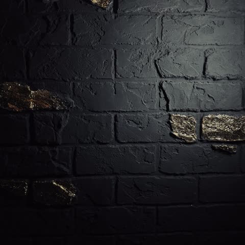 Schwarze Ziegelwand mit Blattgold-Akzenten